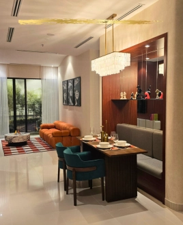 Elegantly furnished show unit interior at SCP Westfield Residences USJ 1 featuring a modern dining table setup, warm lighting, and a cozy sofa lounge.