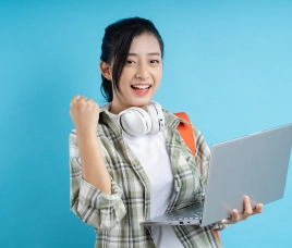 Happy student holding a laptop and backpack representing the large university tenant pool near SCP Westfield Residences USJ 1.