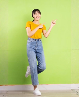 Cheerful young woman pointing towards key lifestyle amenities and transit connections available at SCP Westfield Residences USJ 1.